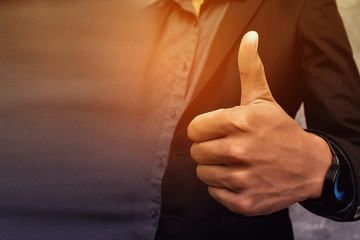 Business people give a thumbs up to show appreciation and are happy to praise the achievements of...