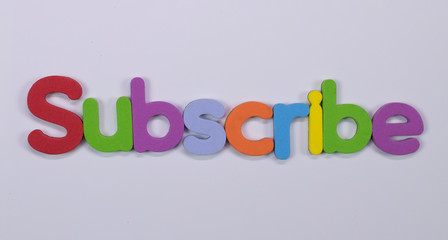 Word Subscribe written with color sponge