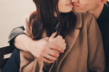 Loving couple hug sitting on the street.