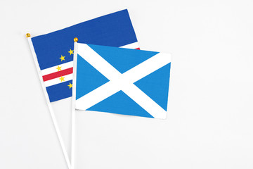 Scotland and Cape Verde stick flags on white background. High quality fabric, miniature national flag. Peaceful global concept.White floor for copy space.