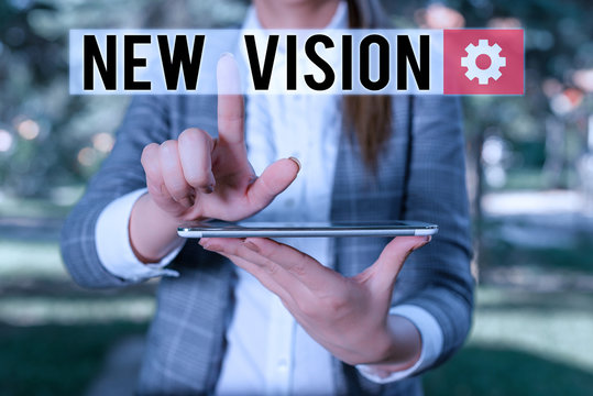 Text sign showing New Vision. Business photo text seeing some future developments Hopeful about the future Outdoor scene with business woman holds lap top with touch screen