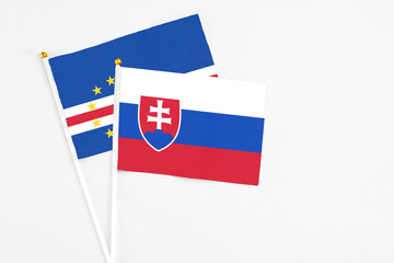 Slovakia and Cape Verde stick flags on white background. High quality fabric, miniature national flag. Peaceful global concept.White floor for copy space.
