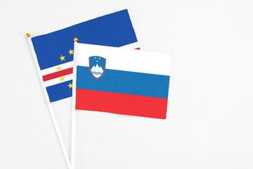 Slovenia and Cape Verde stick flags on white background. High quality fabric, miniature national flag. Peaceful global concept.White floor for copy space.