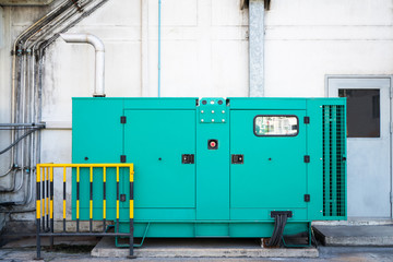 Green auxiliary diesel generator for emergency electric power  outage in the factory. - obrazy, fototapety, plakaty