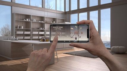 Smart remote home control system on a digital tablet. Device with app icons. Modern kitchen with...
