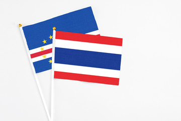 Thailand and Cape Verde stick flags on white background. High quality fabric, miniature national flag. Peaceful global concept.White floor for copy space.