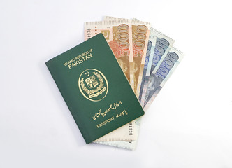 Pakistani Green Passport with one and five thousand rupees currency notes