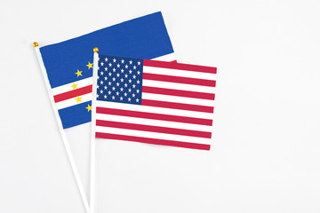United States and Cape Verde stick flags on white background. High quality fabric, miniature national flag. Peaceful global concept.White floor for copy space.
