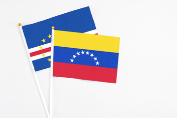 Venezuela and Cape Verde stick flags on white background. High quality fabric, miniature national flag. Peaceful global concept.White floor for copy space.
