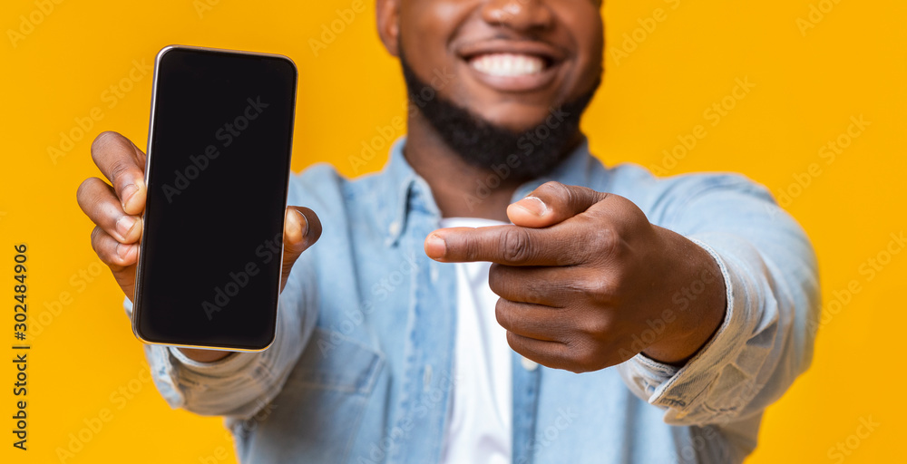 Poster Man holding smartphone with black screen and pointing on it