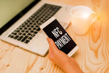 Writing note showing Nfc Payment. Business concept for contactless payment that use nearfield communication technology woman with laptop smartphone and office supplies technology