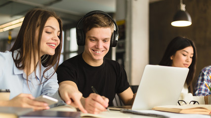 Two students girl and boy studying together in library