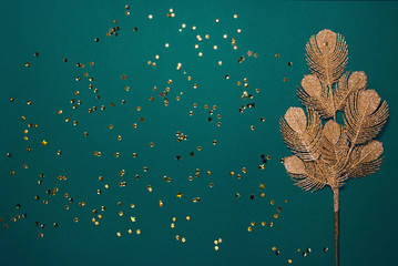 Golden decorative branch and sequins on bright background. Christmas backdrop. Celebration and...