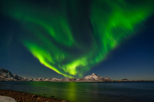 Northern Lights, Aurora borealis with mountains in background over Senja, Norway
