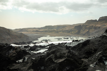 Fototapeta na wymiar View from the ash covered Solheimajokull glacier toward the fjord