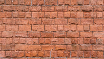 Square and rough orange brick wall. Background image.