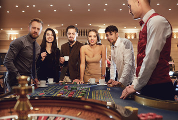 Group of people gambling at roulette poker in a casino