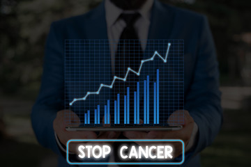 Conceptual hand writing showing Stop Cancer. Concept meaning prevent the uncontrolled growth of...