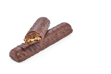 Two chocolate bars lying one on top of the other, one of which is bitten, isolated on a white background with shadows.
