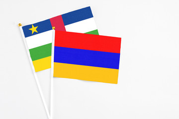 Armenia and Central African Republic stick flags on white background. High quality fabric, miniature national flag. Peaceful global concept.White floor for copy space.
