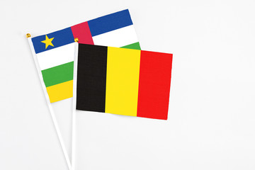 Belgium and Central African Republic stick flags on white background. High quality fabric, miniature national flag. Peaceful global concept.White floor for copy space.