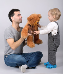 Baby boy and father with teddy bear