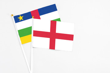 England and Central African Republic stick flags on white background. High quality fabric, miniature national flag. Peaceful global concept.White floor for copy space.