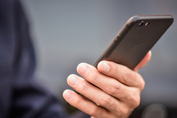 Businessman holding cell phone using Mobile phone or Smart phone Telephone to call phone with Social media Icon technology by WiFi internet