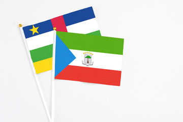 Equatorial Guinea and Central African Republic stick flags on white background. High quality fabric, miniature national flag. Peaceful global concept.White floor for copy space.
