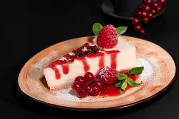 Delicious strawberry cheesecake slice and fresh berries on table close up