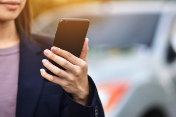 BusinessWoman holding cell phone using Mobile phone or Smart phone Telephone to call phone with Social media Icon technology by WiFi internet