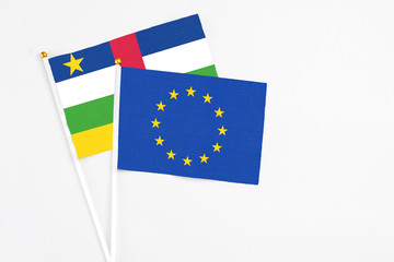 European Union and Central African Republic stick flags on white background. High quality fabric, miniature national flag. Peaceful global concept.White floor for copy space.