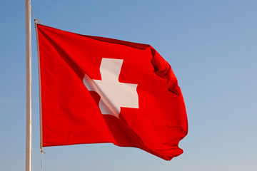 The Flag of Switzerland flutters in the wind