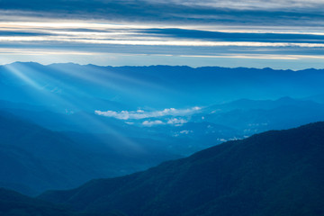 Beautiful Landscape of mountain layer in morning sun ray and green forest.The sunrise shines down the green forest mountain in Thailand.