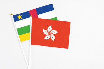 Hong Kong and Central African Republic stick flags on white background. High quality fabric, miniature national flag. Peaceful global concept.White floor for copy space.