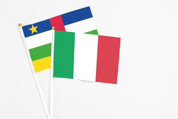 Italy and Central African Republic stick flags on white background. High quality fabric, miniature national flag. Peaceful global concept.White floor for copy space.