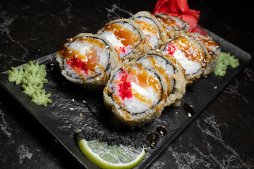 rolls on black background.rice and fish