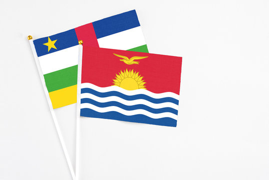 Kiribati and Central African Republic stick flags on white background. High quality fabric, miniature national flag. Peaceful global concept.White floor for copy space.