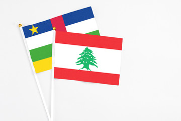 Lebanon and Central African Republic stick flags on white background. High quality fabric, miniature national flag. Peaceful global concept.White floor for copy space.