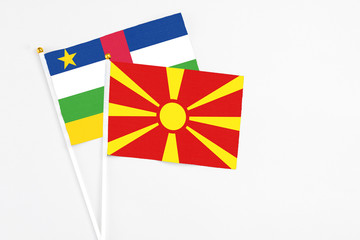 Macedonia and Central African Republic stick flags on white background. High quality fabric, miniature national flag. Peaceful global concept.White floor for copy space.