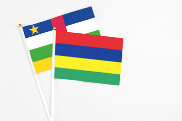 Mauritius and Central African Republic stick flags on white background. High quality fabric, miniature national flag. Peaceful global concept.White floor for copy space.