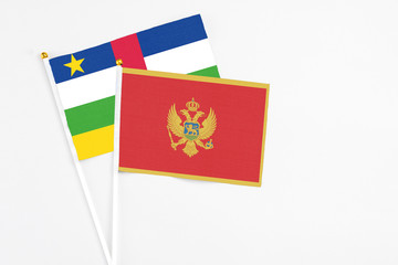 Montenegro and Central African Republic stick flags on white background. High quality fabric, miniature national flag. Peaceful global concept.White floor for copy space.