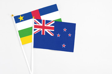 New Zealand and Central African Republic stick flags on white background. High quality fabric, miniature national flag. Peaceful global concept.White floor for copy space.