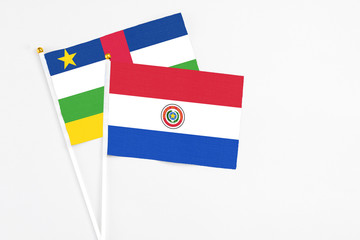 Paraguay and Central African Republic stick flags on white background. High quality fabric, miniature national flag. Peaceful global concept.White floor for copy space.