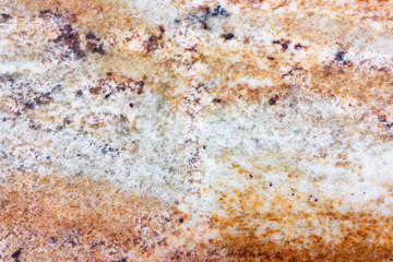 Texture of golden granite stone. Golden marble background.