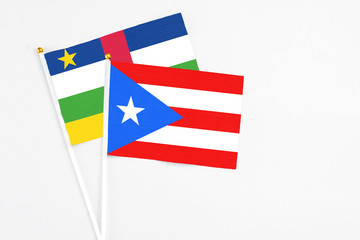 Puerto Rico and Central African Republic stick flags on white background. High quality fabric, miniature national flag. Peaceful global concept.White floor for copy space.