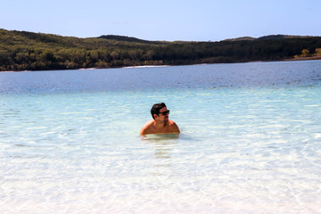 Caucasion guy relaxing in Lake McKenzie on Fraser Island, Australia