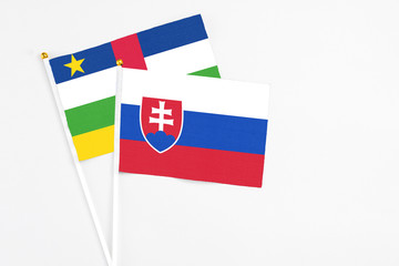 Slovakia and Central African Republic stick flags on white background. High quality fabric, miniature national flag. Peaceful global concept.White floor for copy space.