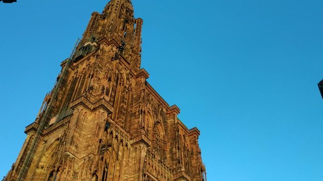 Strasbourg, France.August 2019. Our Lady's magnificent cathedral, with its 142 meters of height, was for comparison time for taller buildings. The reddish fa&ccedil;ade is impressive. Tilt movement.