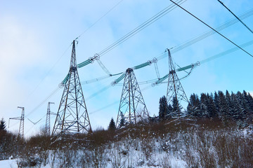 Transposition power transmission towers in snowy mountains. Glaciation of electricity power lines...